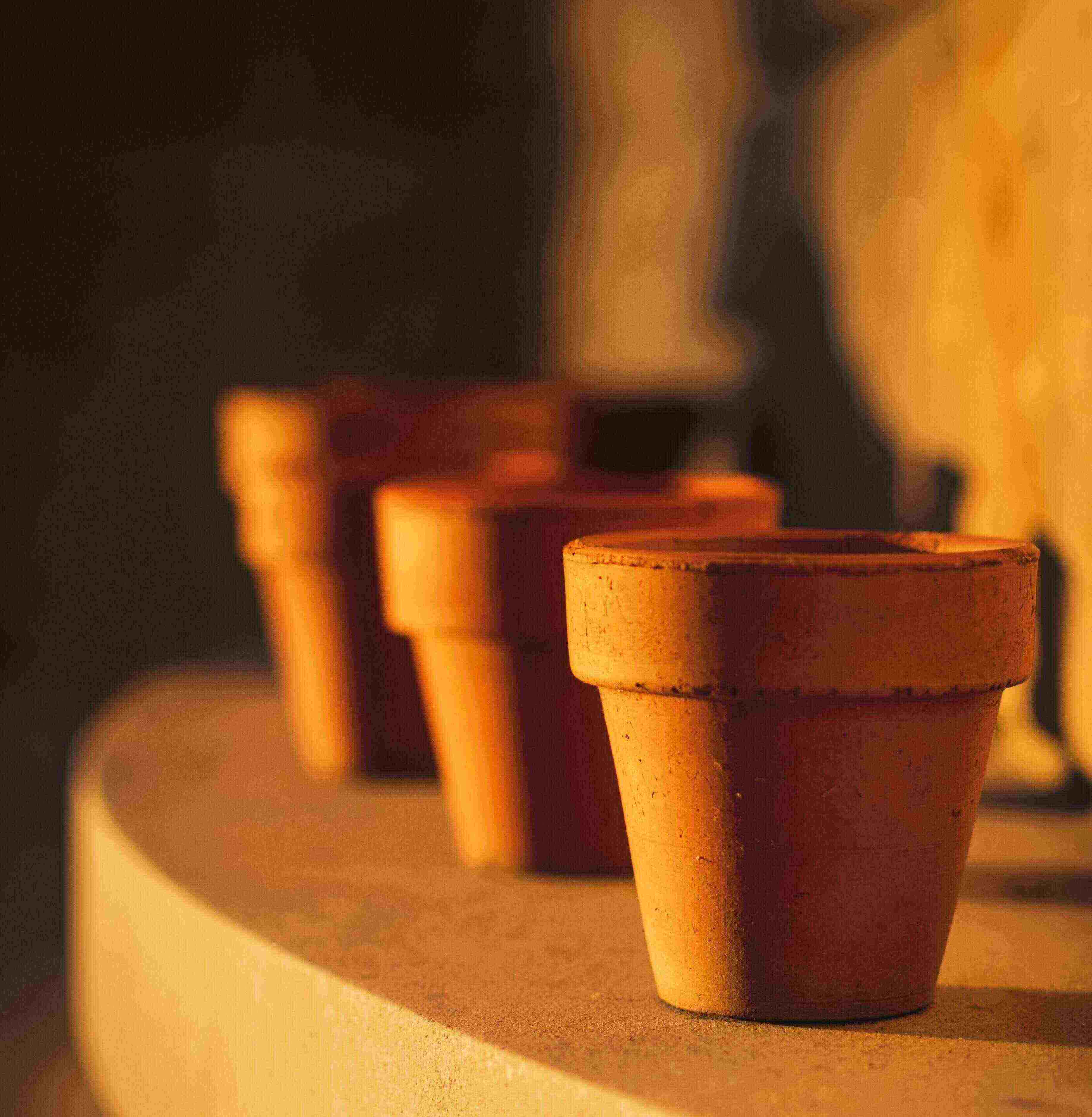 Three earthenware pots on a ledge