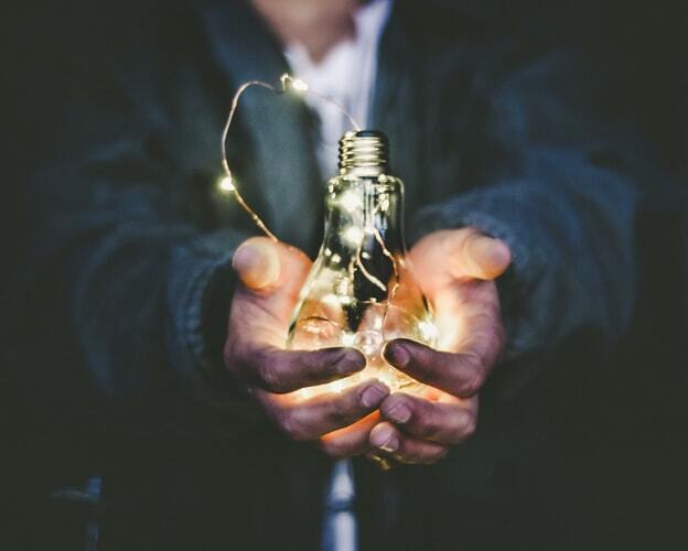 A man holding a light bulb