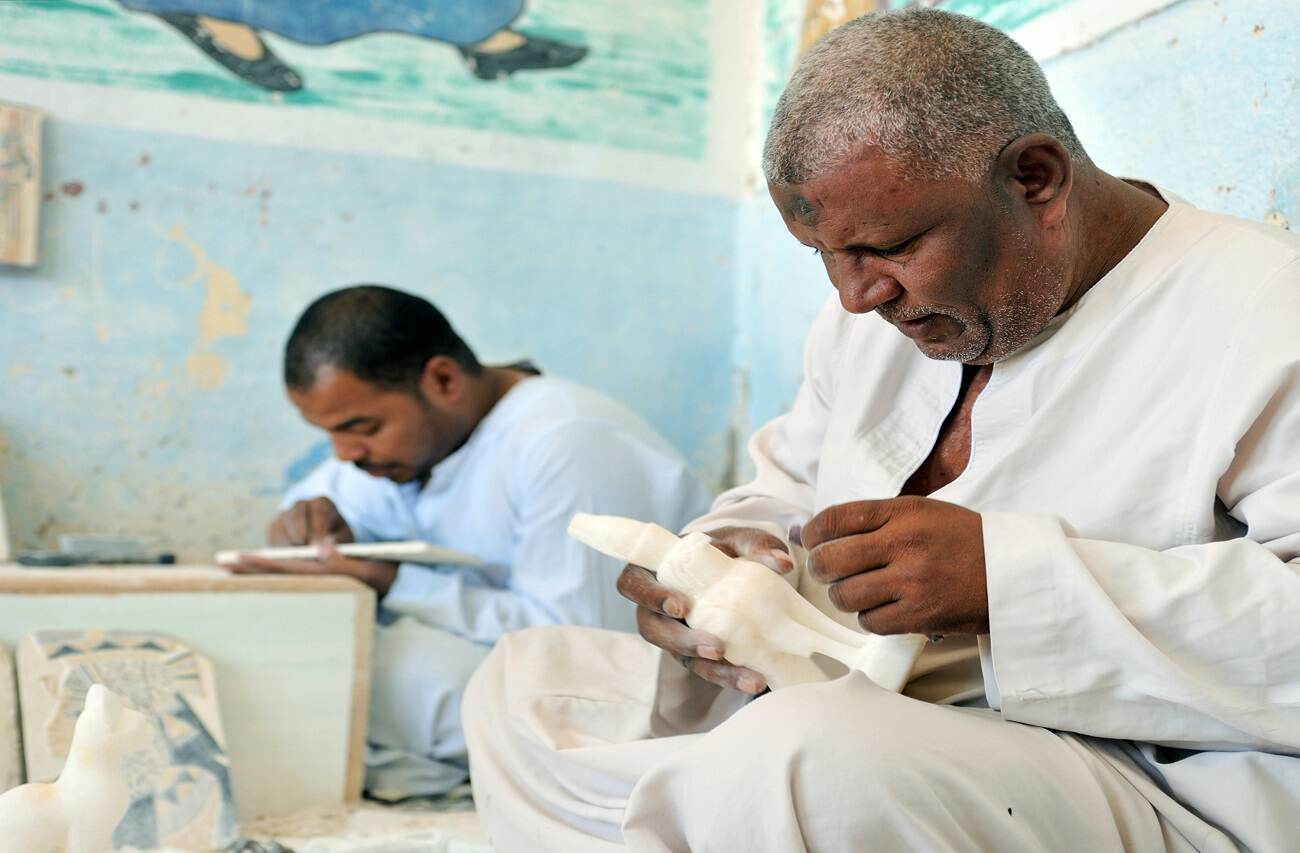 An artisan working on a marble artefact