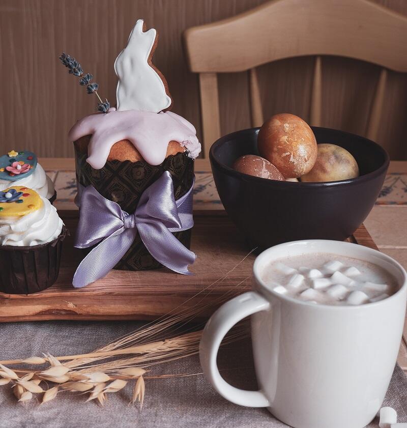 Easter platter with eggs in a bowl, muffins and marshmallow drink