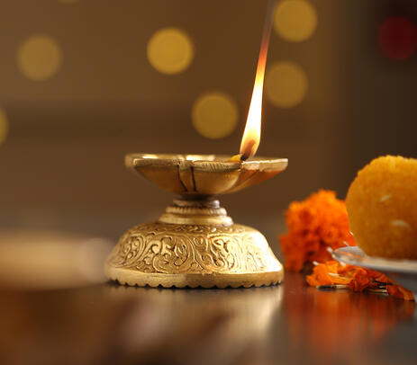 A lit brass diya