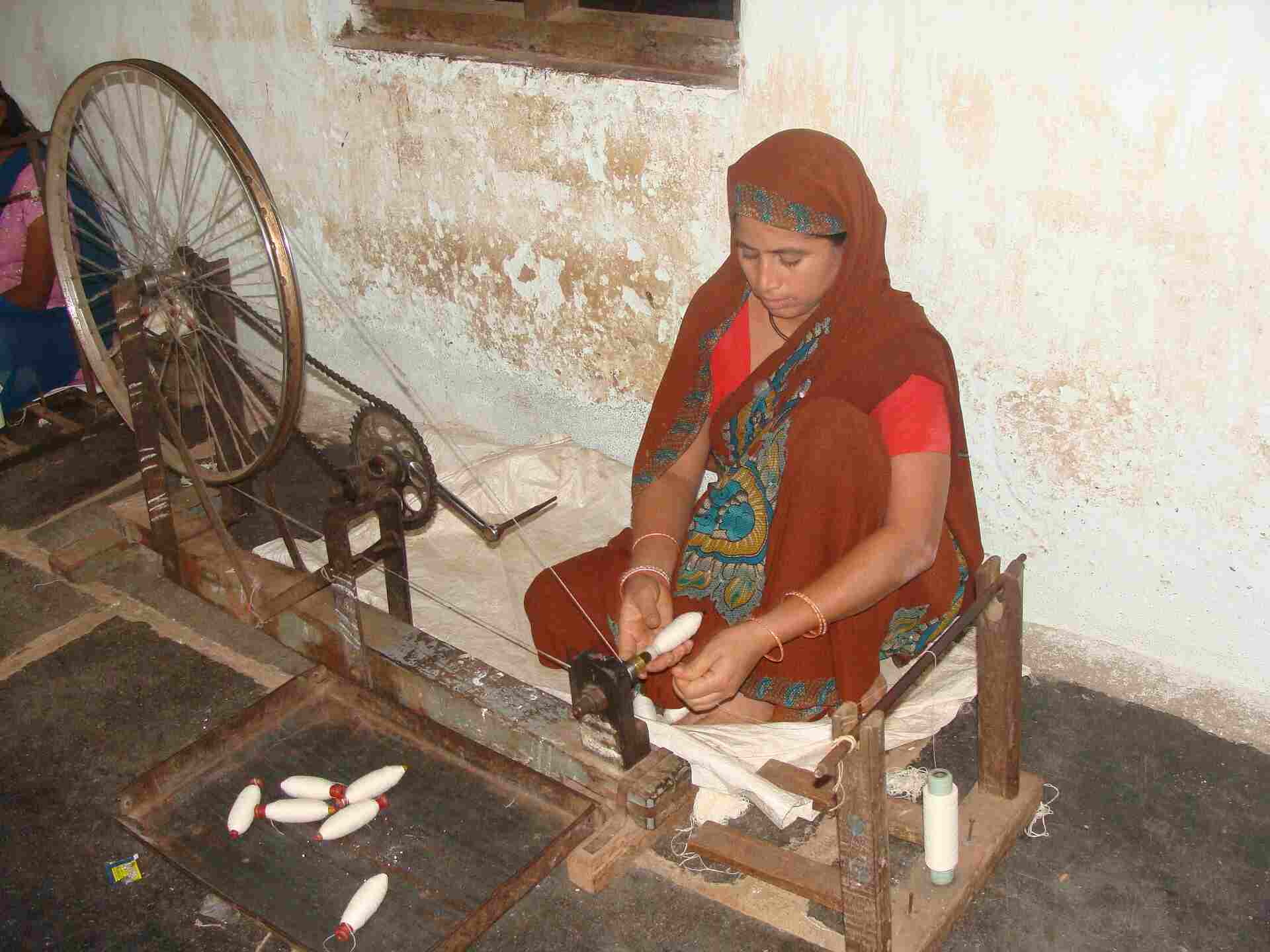 An Indian woman spinning Khadi on a charkha