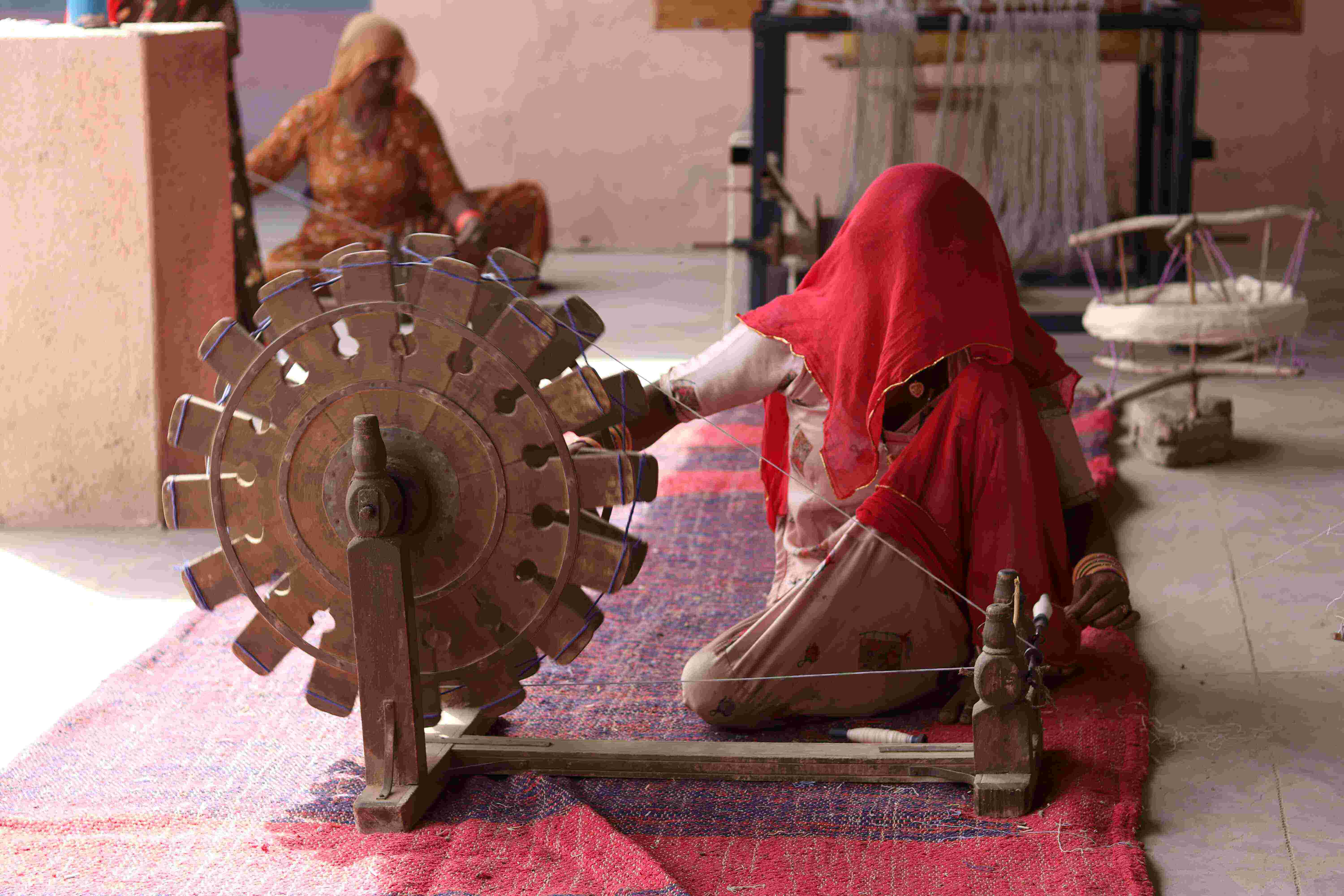 An Indian woman spinning Khadi on a charkha