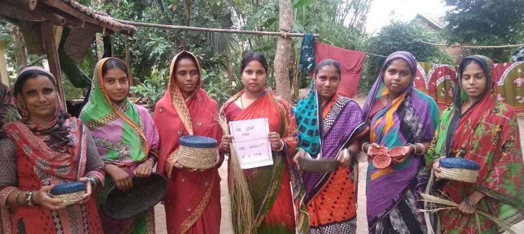 Seven rural women artisans holding the products they have made