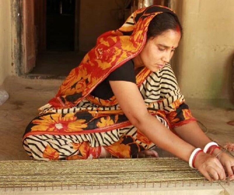 A rural woman artisan handcrafting a product