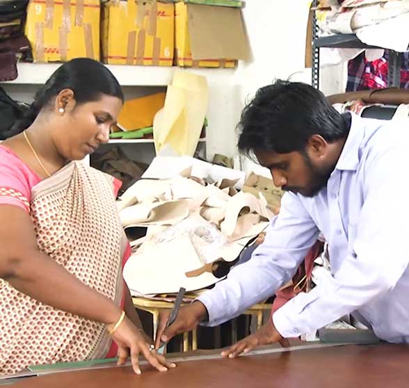 Woman and man artisans handcraft a bag