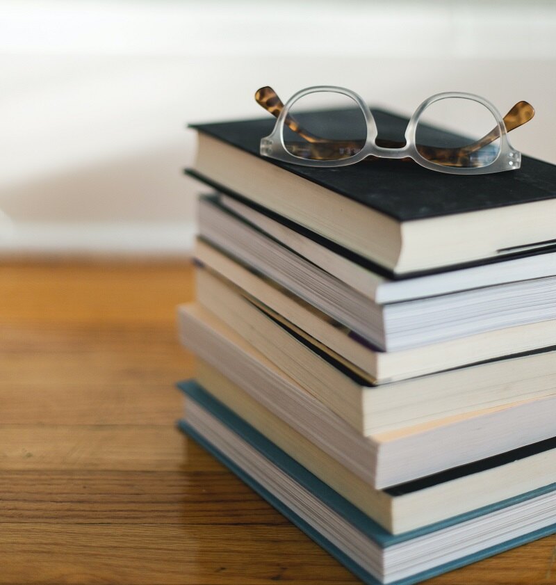 Stack of books with spectacles on top