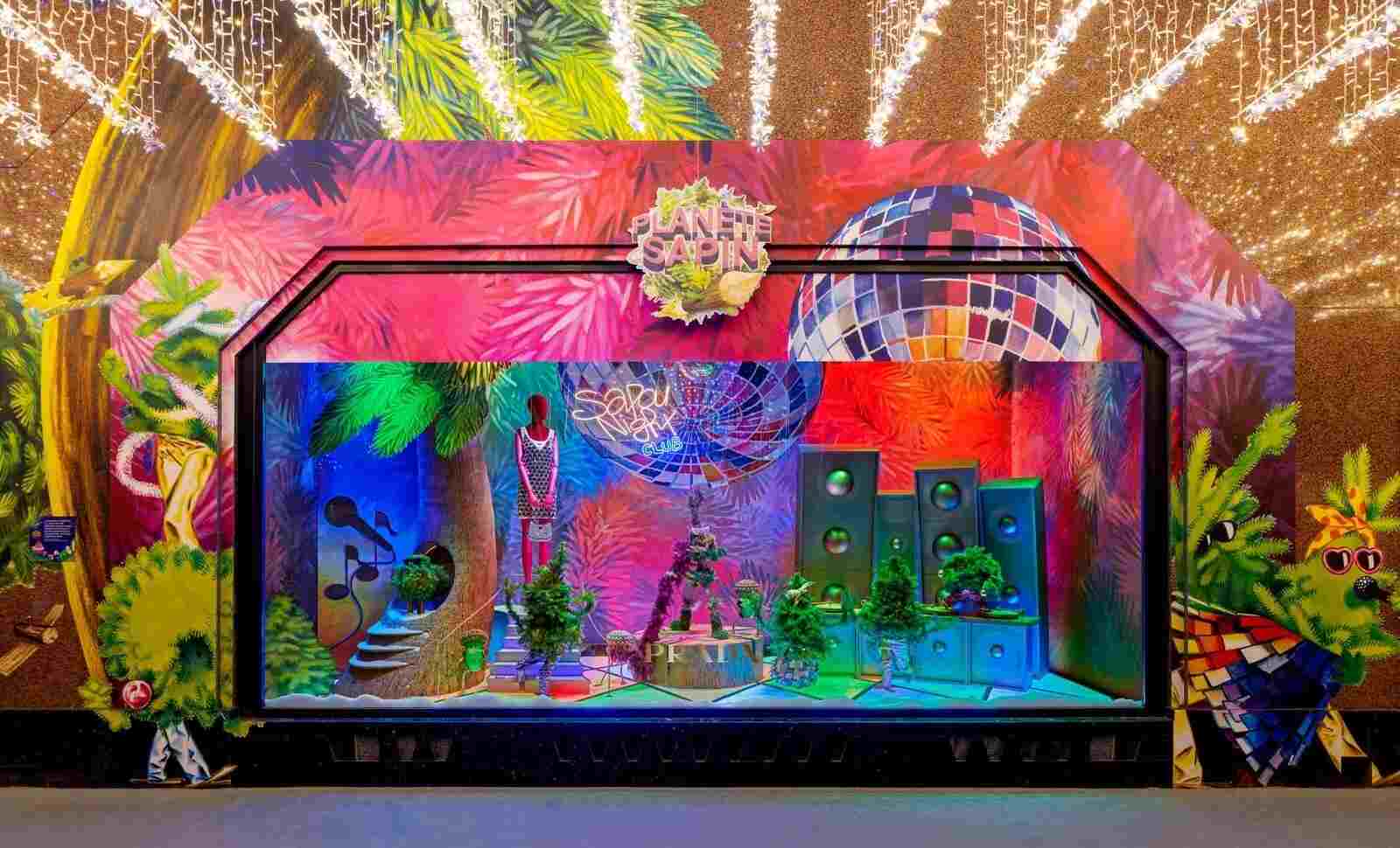 Very Peri color theme storefront with a music-motif vivid set-up consisting boom boxes, speakers, musical notes, a mannequin and a disco ball