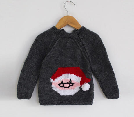 Hand knitted sweater with santa claus patch