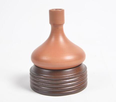 Earthy terracotta candle holder with wooden stand