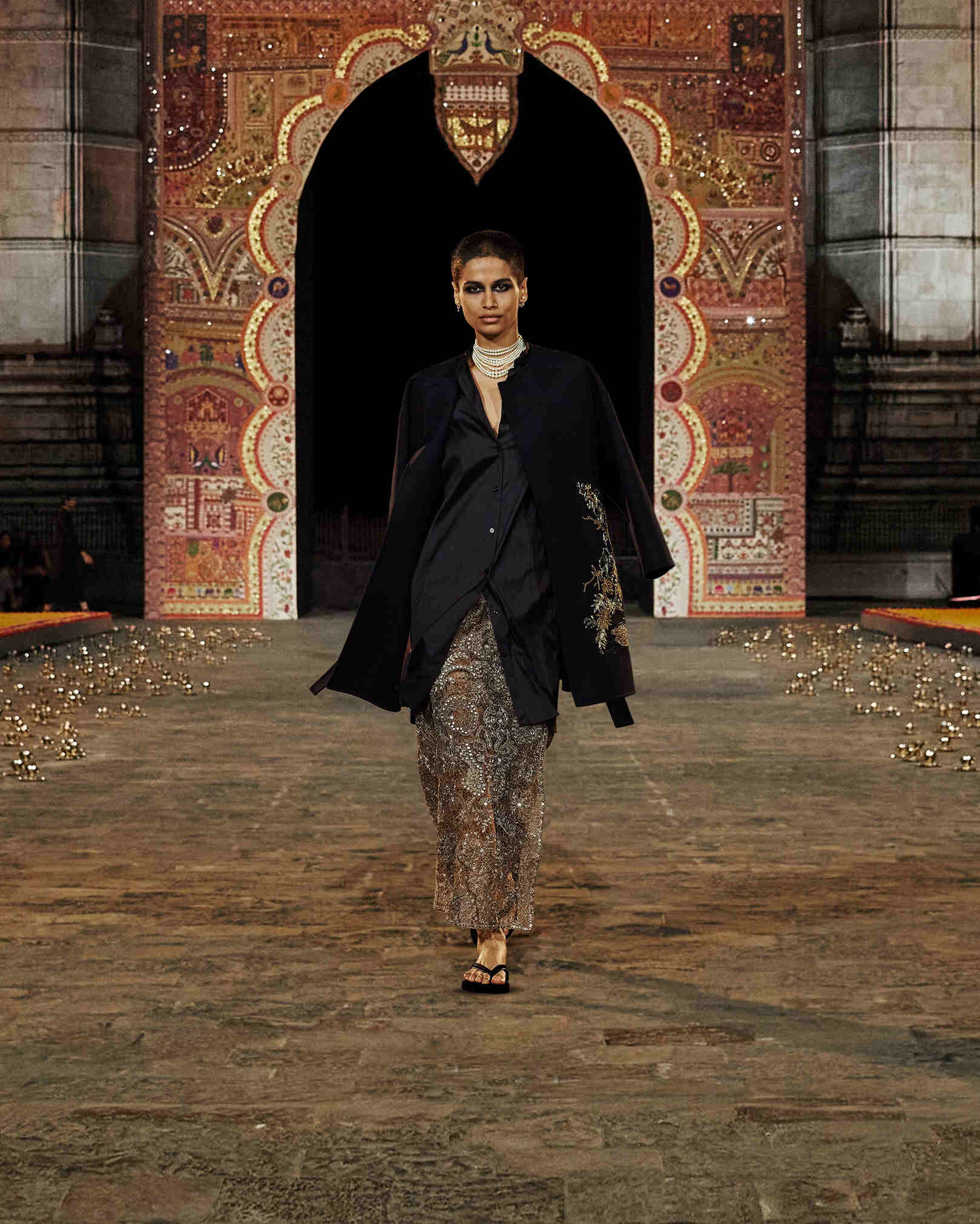 Model walking the ramp donning a garment that features zardozi work