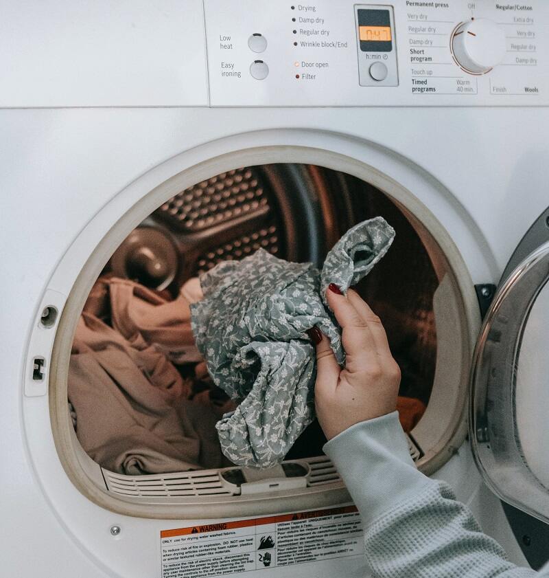 A clothing article being put in the machine for wash