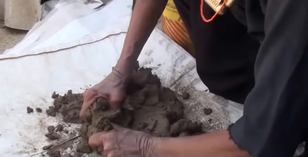 Kneading dough of dung and mud