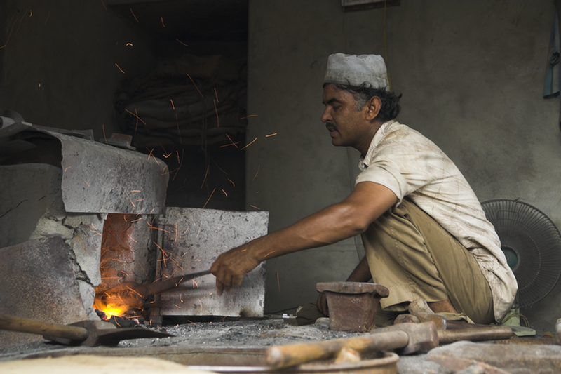 The bell being put inside a furnace for baking