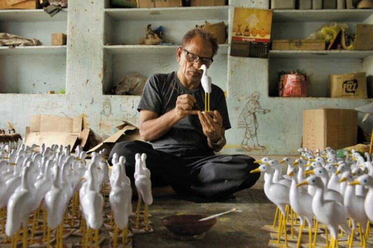 Artisan practising Nirmal toy making craft