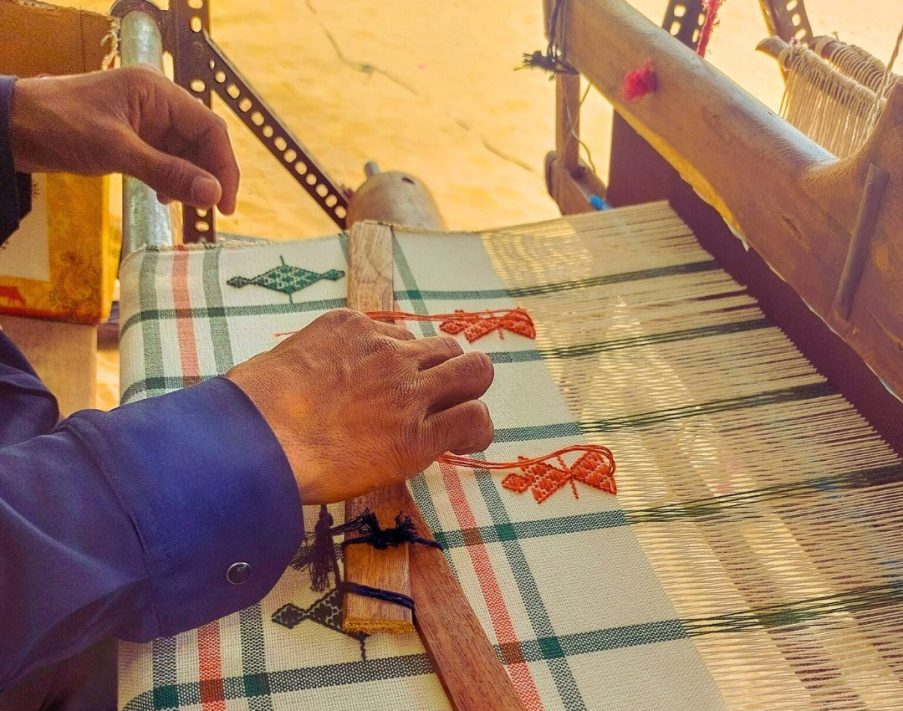 An artisan engaged in handweaving